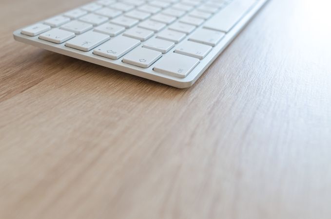 White Keyboard On Wooden Table Photo
