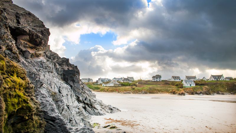 White Sand Beside Grey Rock Cliff On Beach Photo