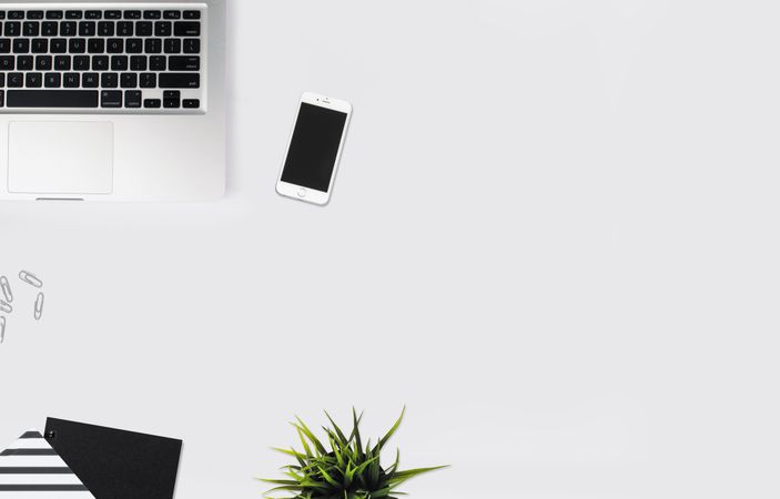 White Smartphone Beside Silver Laptop Computer Photo