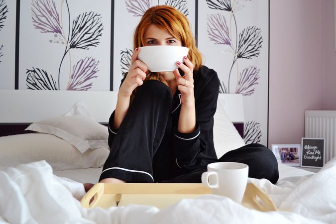 Woman Drinking Coffee In Bedroom Photo
