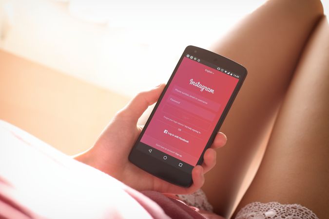 Woman Holding Android Phone And Using Social Media Application Photo
