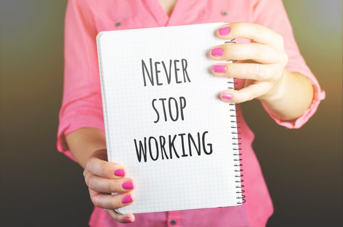 Woman Holding Never Stop Working Print Notebook Photo