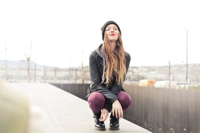 Woman In Gray Hooded Jacket Doing Crouch Position Photo