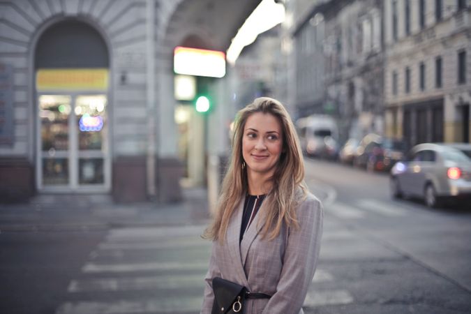 Woman In Gray Suit Jacket Near Gray Car Photo