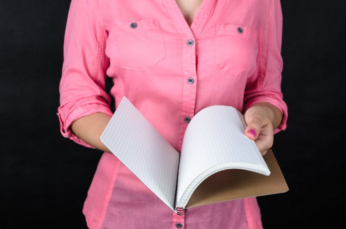 Woman In Pink Shirt Checking Notebook Photo