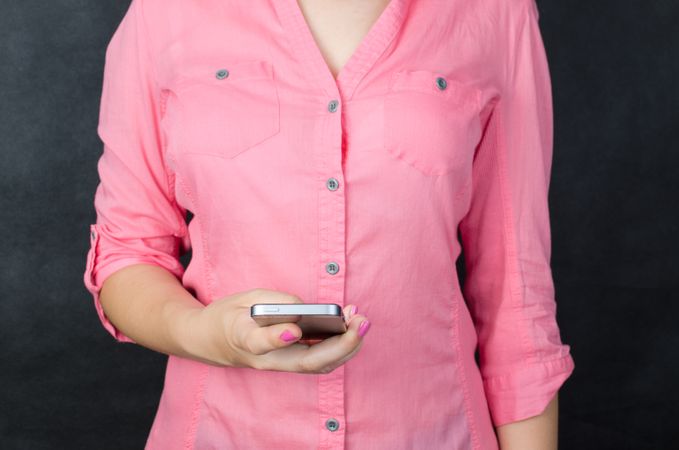Woman In Pink Shirt Holding Cellphone Photo