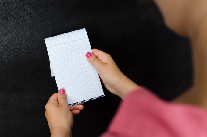 Woman In Pink Shirt Holding Grid Paper In Her Hands Photo
