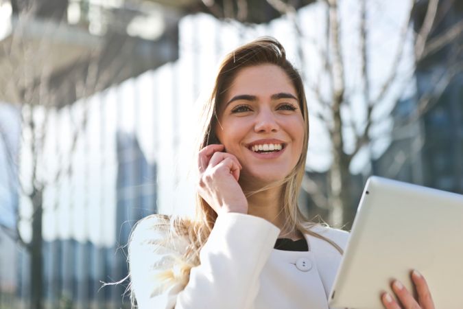 Woman In White Blazer Holding Tablet Computer Photo