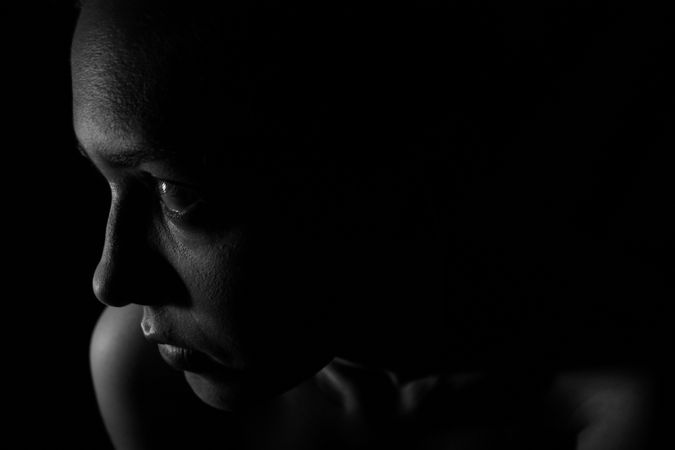 Woman's Face In Dark Room Photo