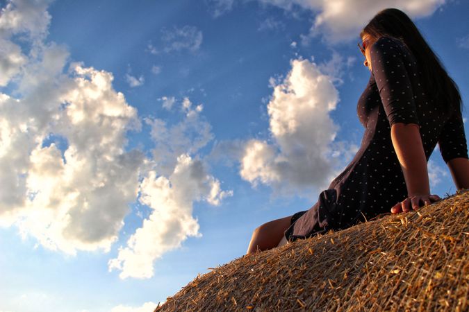 Woman Standing On Mountain Against Cloudy Sky Photo