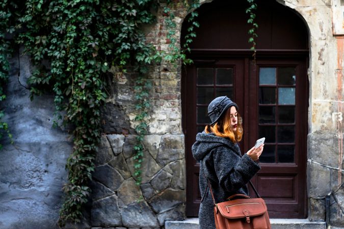 Woman Staring His Mobile In Front Of Building Photo