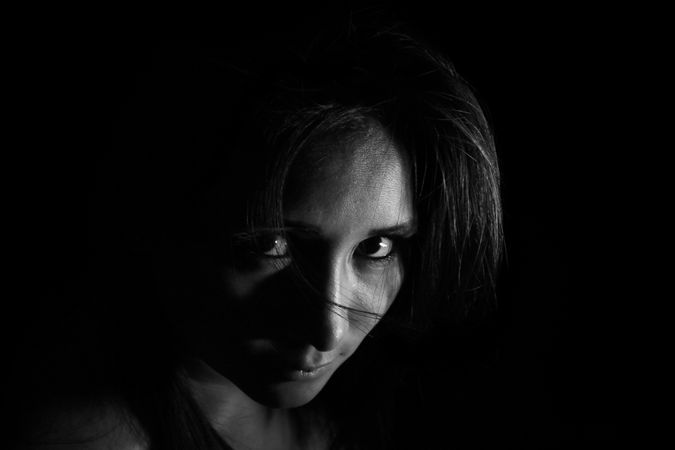 Woman Wearing Black Sleeveless Shirt With Black Background Photo