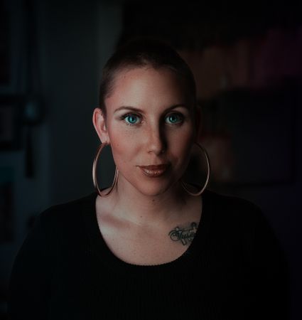 Woman Wearing Earrings And Black Shirt Photo
