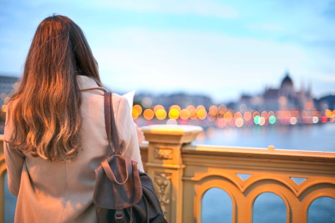 Woman Wearing Trench Coat And Black Leather Backpack Photo