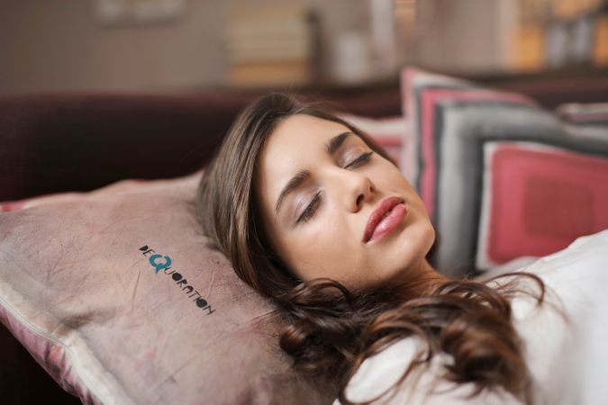 Woman Wearing White Shirt Laying On Bed Photo
