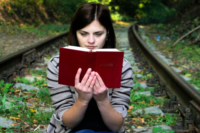 Young Woman Sitting On Bench In Park Photo