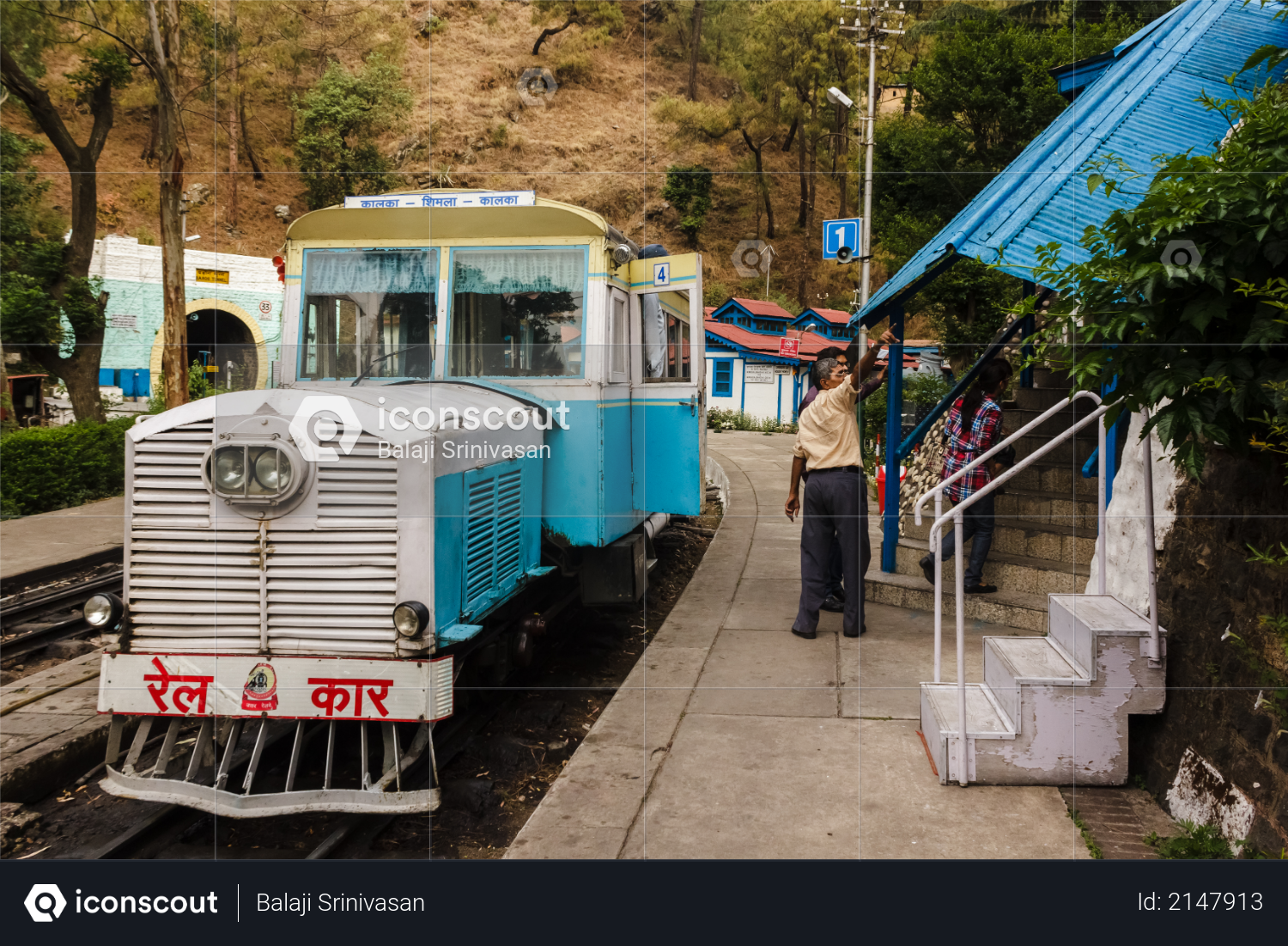 Barog, Himachal Pradesh, India - May 2012: An old passenger Rail Motor car traveling on the narrow gauge railway line between Kalka and Shimla stops at the Barog Railway Station. Photo