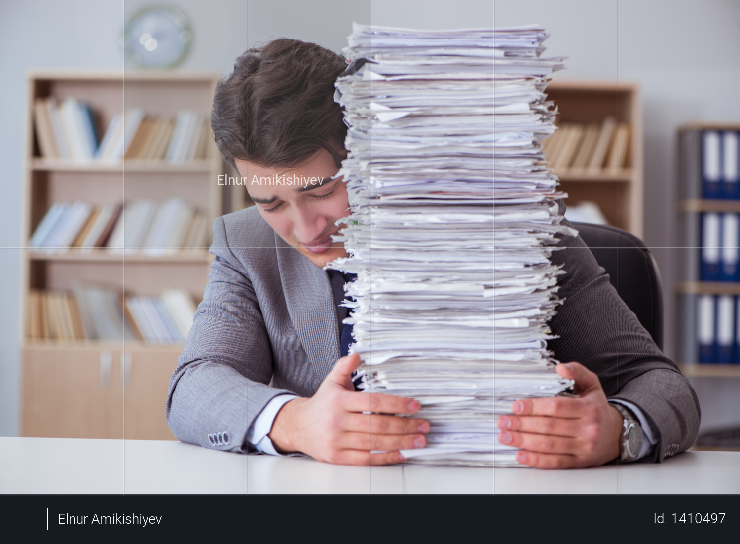 Businessman busy with paperwork in office Photo