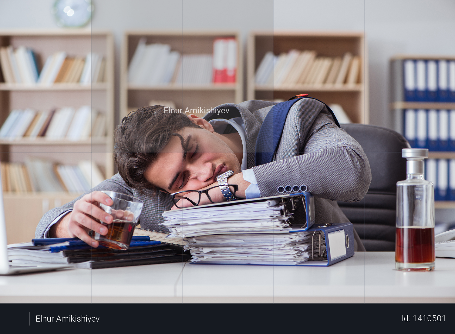 Businessman drinking in the office Photo