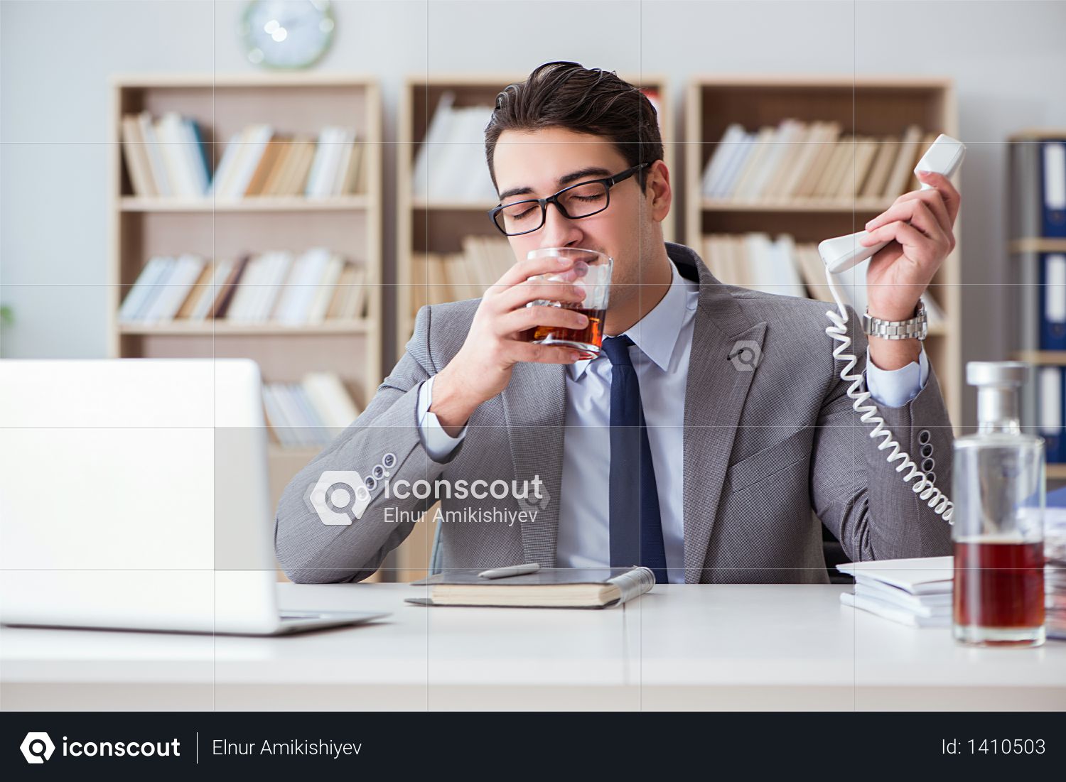 Businessman drinking in the office Photo