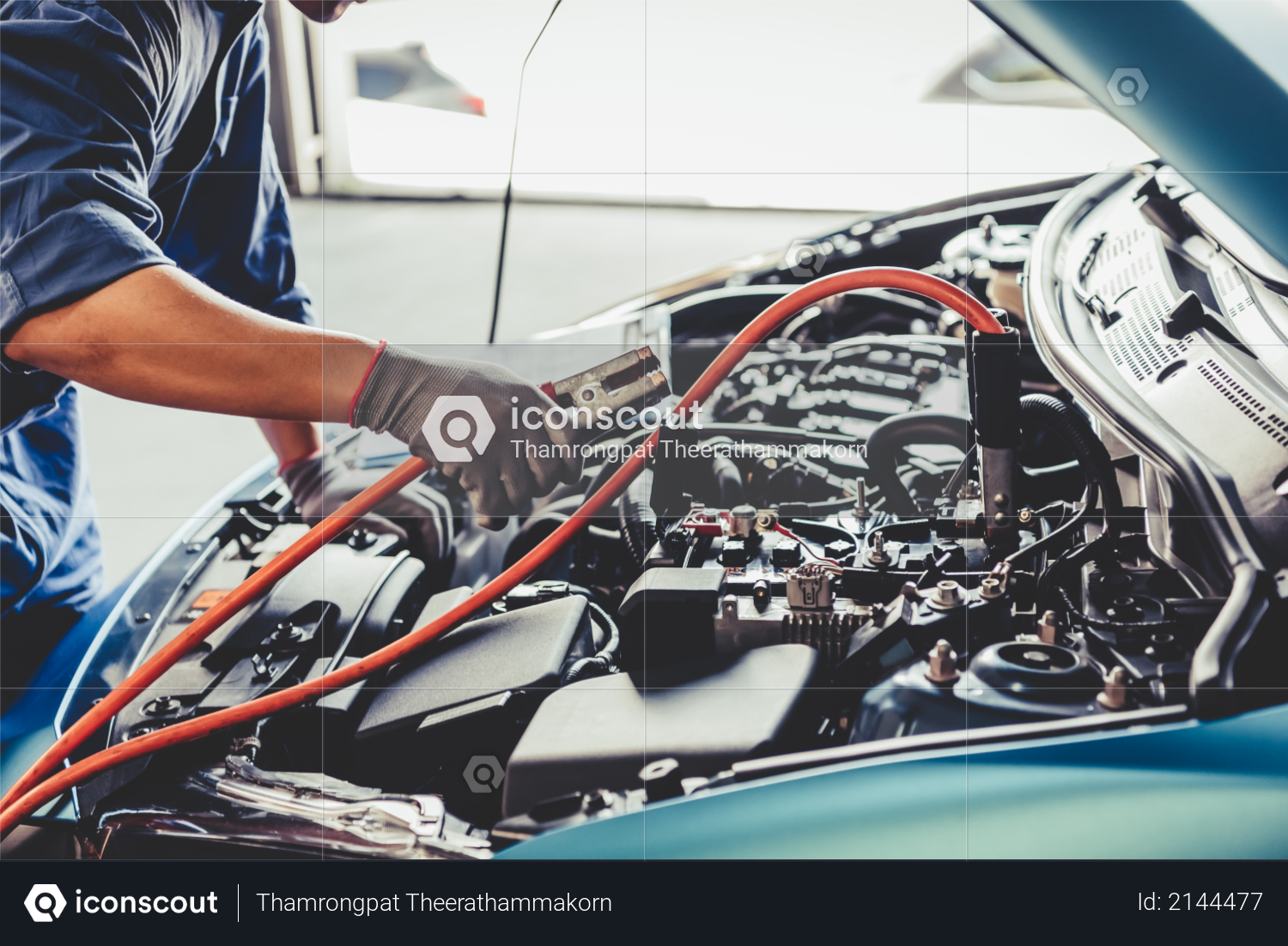 Car mechanic holding battery electricity trough cables jumper and checking to maintenance vehicle by customer claim order in auto repair shop garage - Repair service Photo