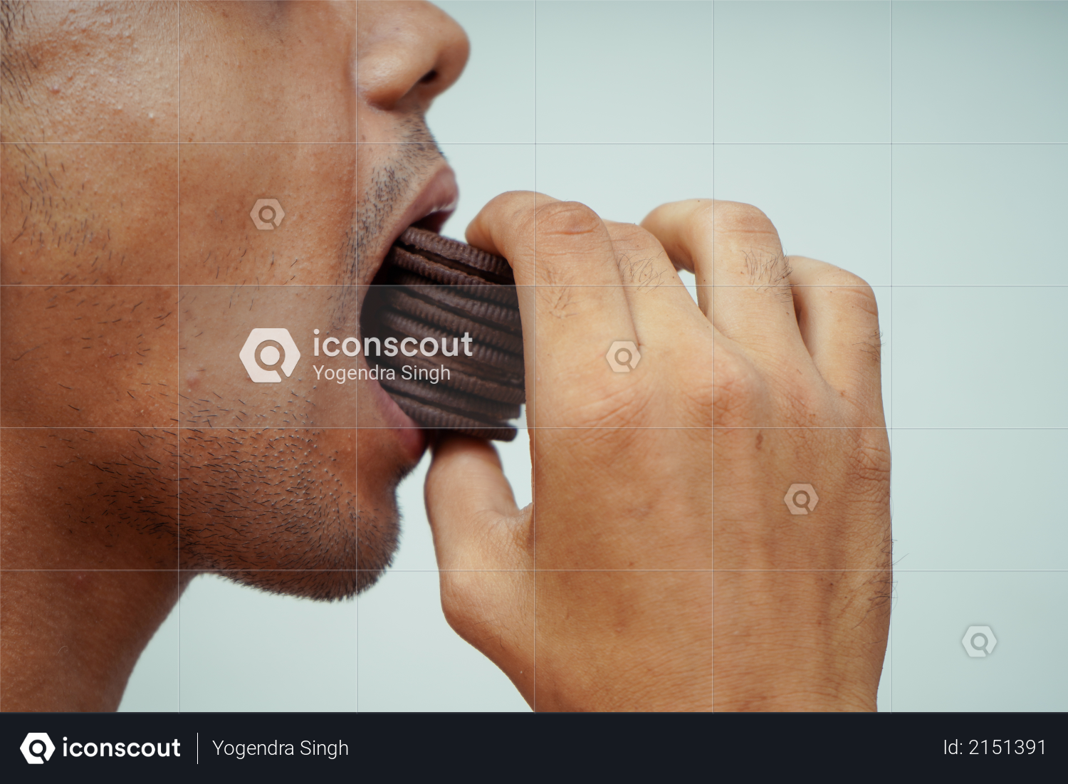 Close up of man eating many chocolate biscuits Photo