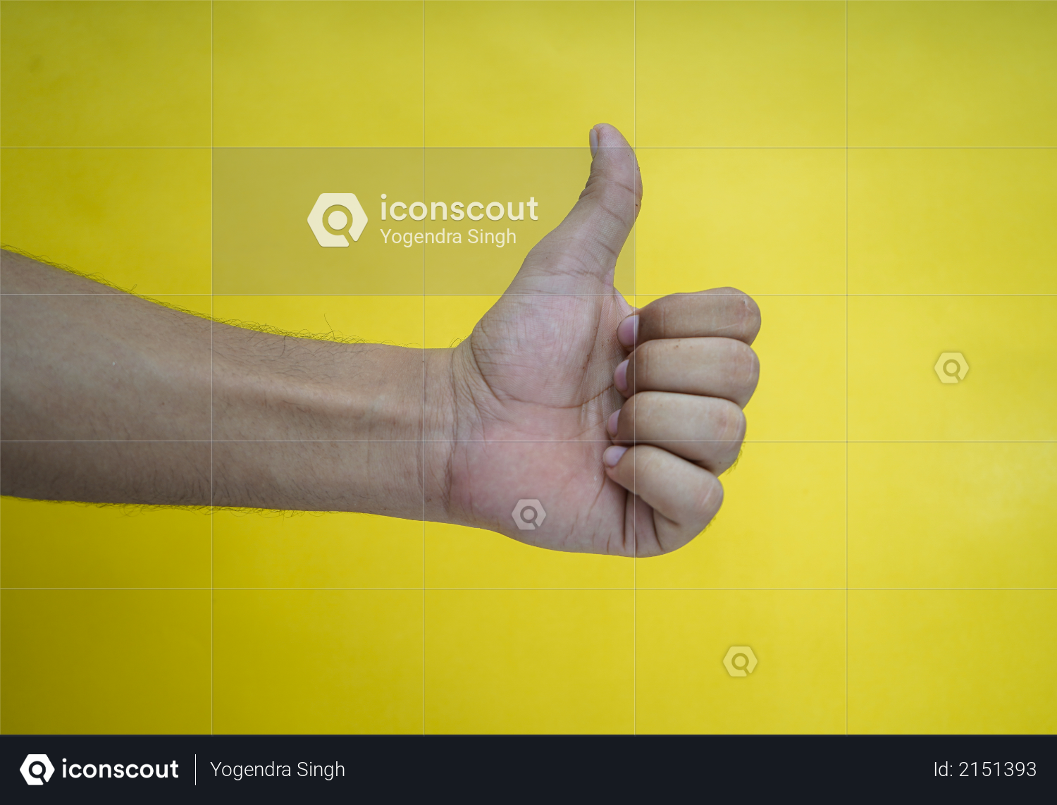 Hand showing thumbs up on a yellow background Photo
