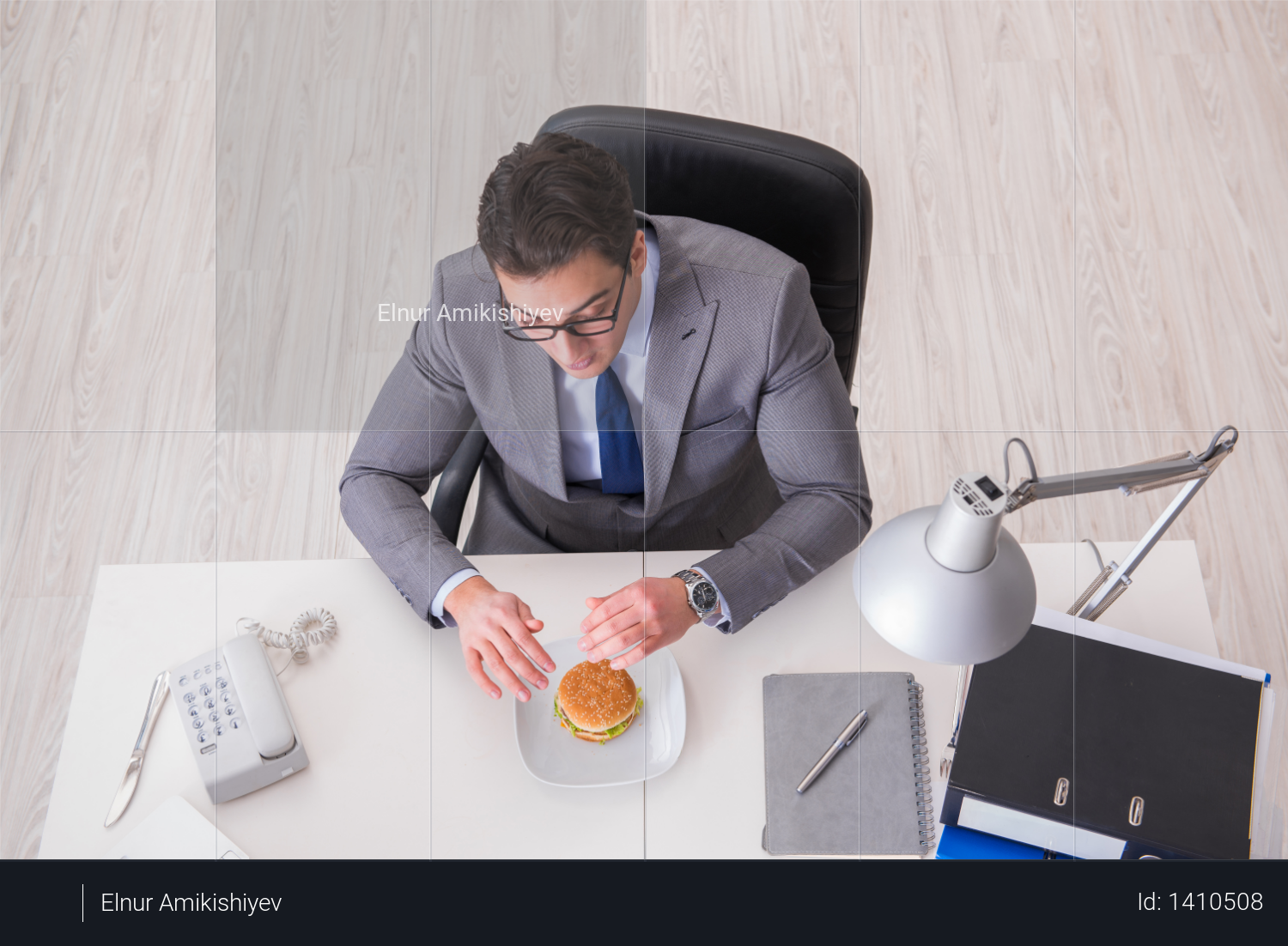 Hungry funny businessman eating junk food sandwich Photo