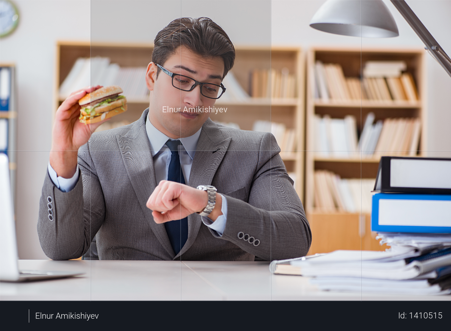 Hungry funny businessman eating junk food sandwich Photo