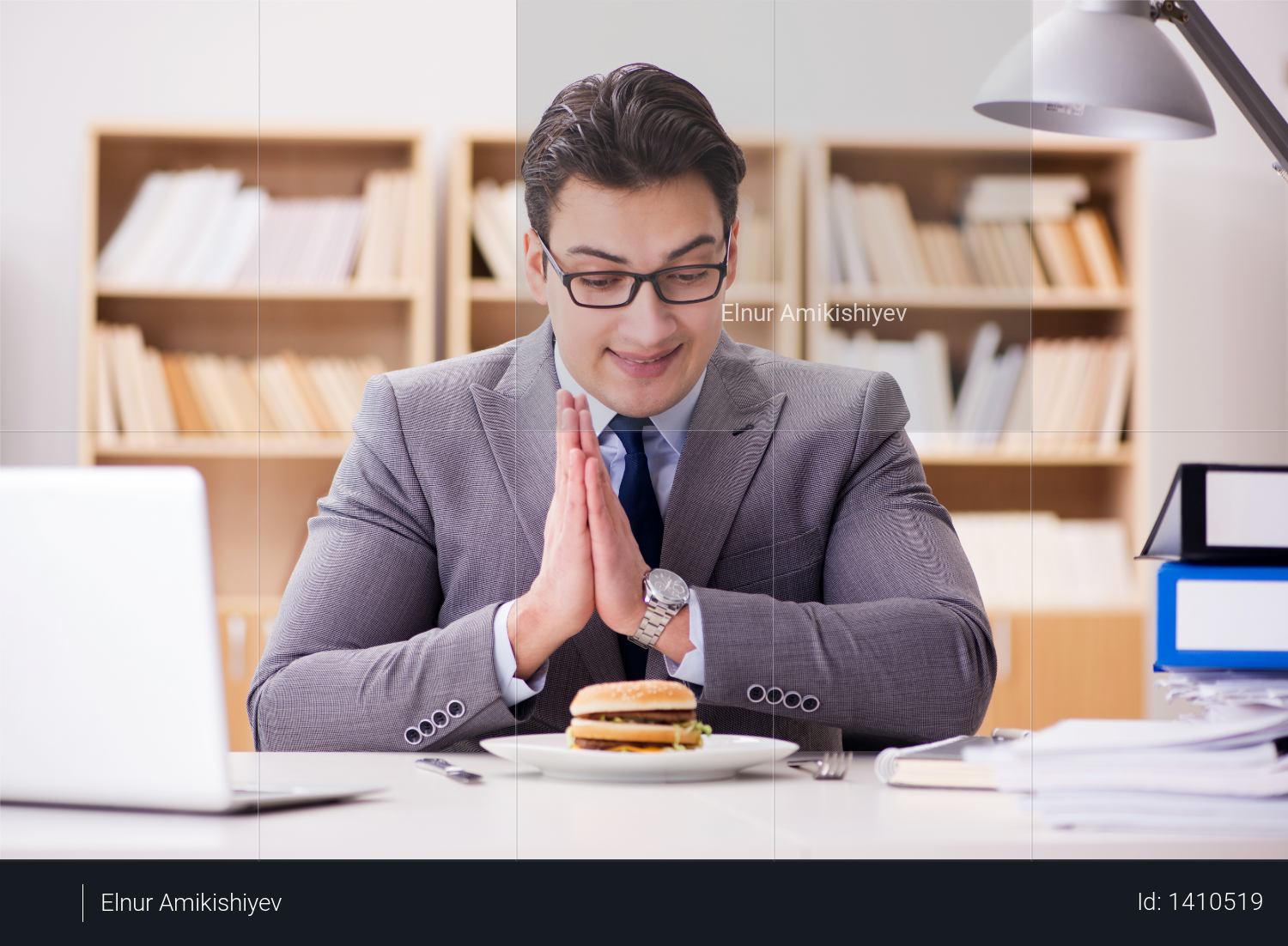 Hungry funny businessman eating junk food sandwich Photo