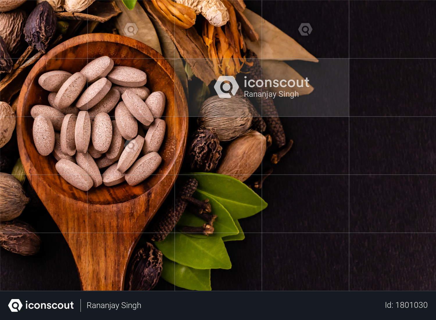 Macro of ayurvedic medicine tablets in a wooden spoon with dry and green herbs on a black backgroun, ayurveda and alternative medicine concept Photo