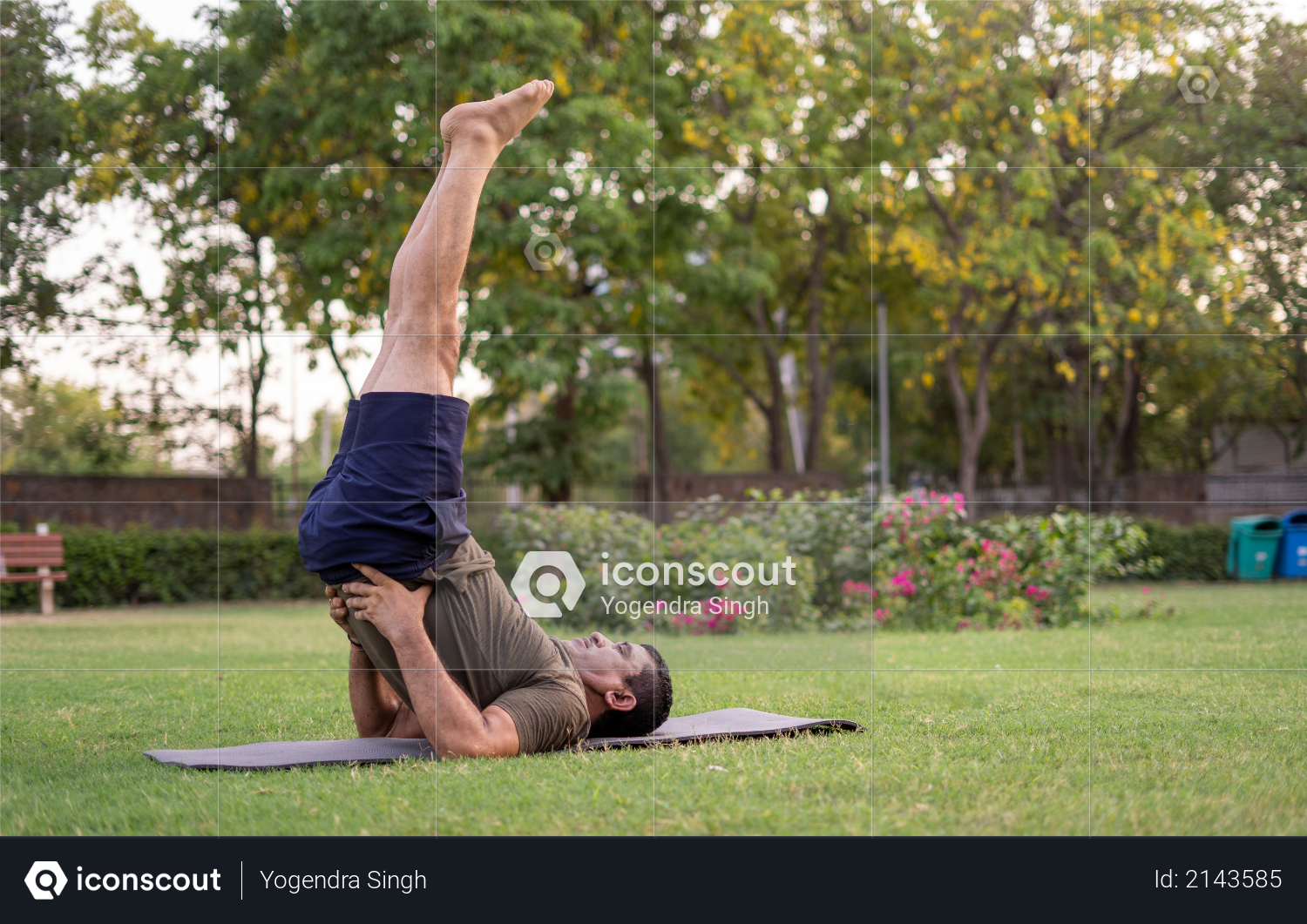 Mid-aged Man doing yoga in a park covered with trees Photo
