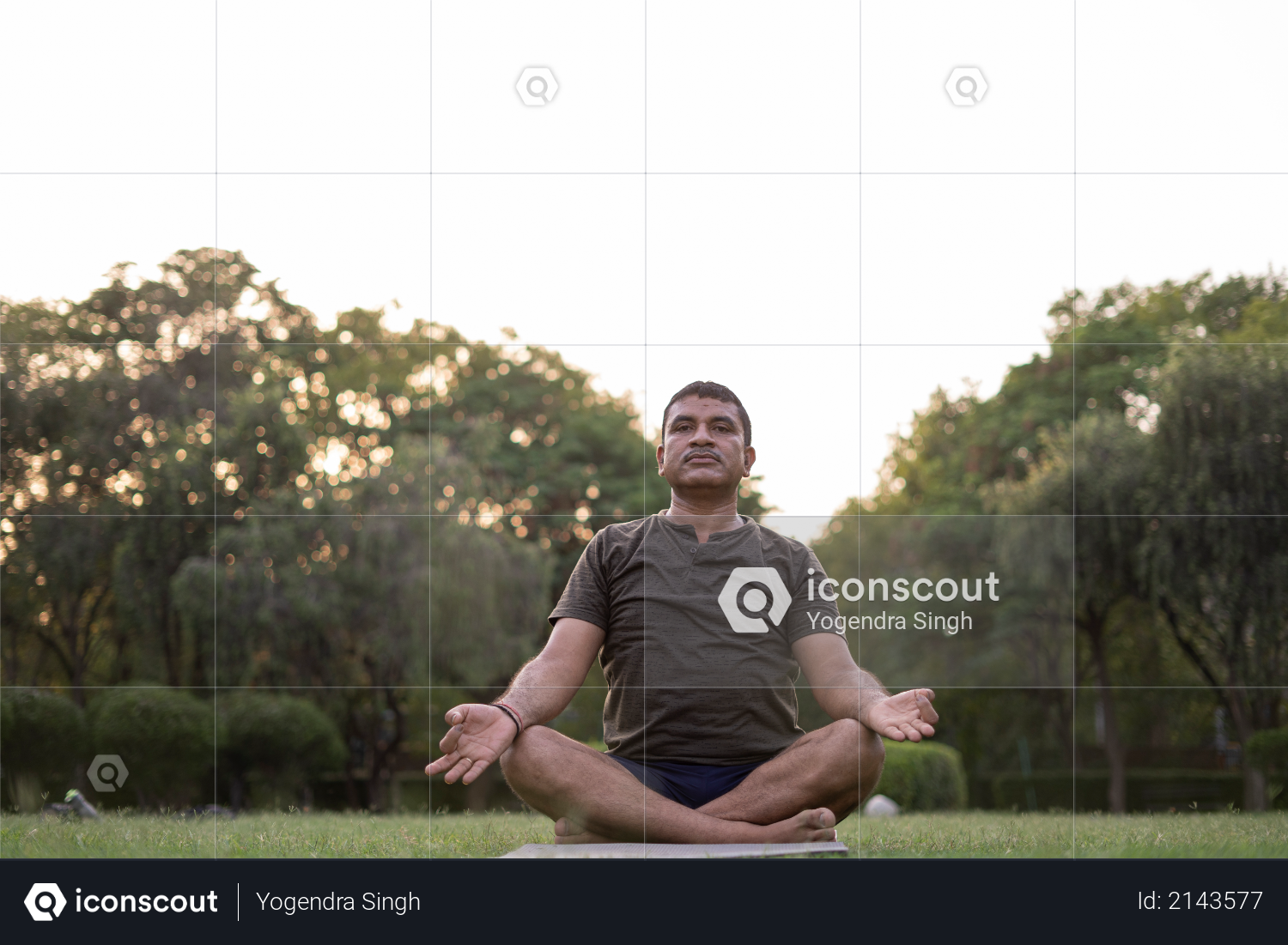 Mid-aged Man doing yoga in a park covered with trees on International Yoga Day Photo