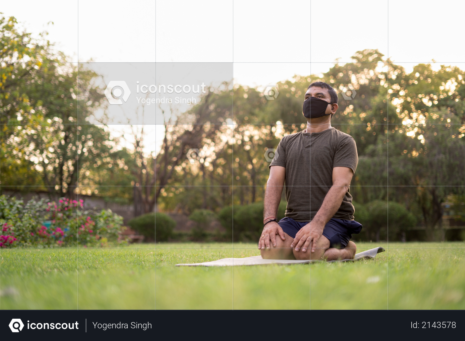 Mid-aged Man doing yoga in a park covered with trees on International Yoga Day Photo