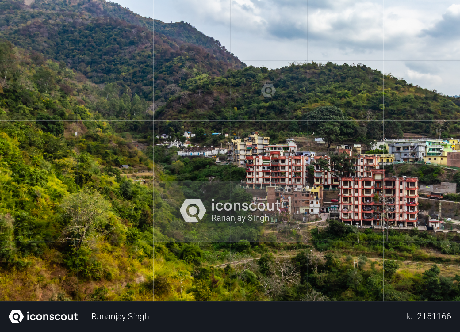 Photography of buildings with mountain range and cloudy sky in the background Photo