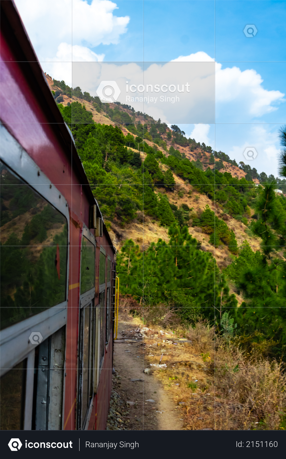 Potrait photography of train and mountain with cloudy blue sky in the background Photo
