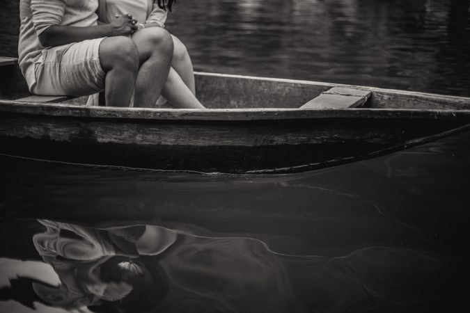 Black And White Photo Of Young Couple Sitting On Boat Photo