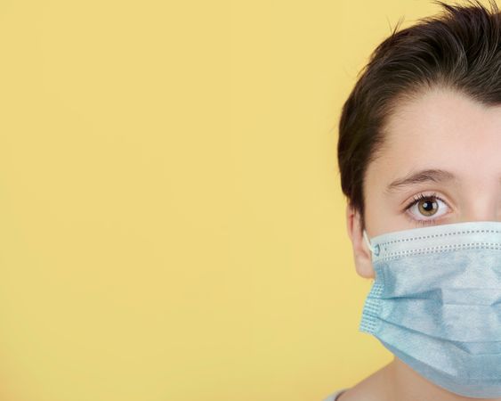 Download Premium Close Up Of Kid Wearing Medical Mask Over Yellow Background Photo Download In Png Jpg Format PSD Mockup Templates