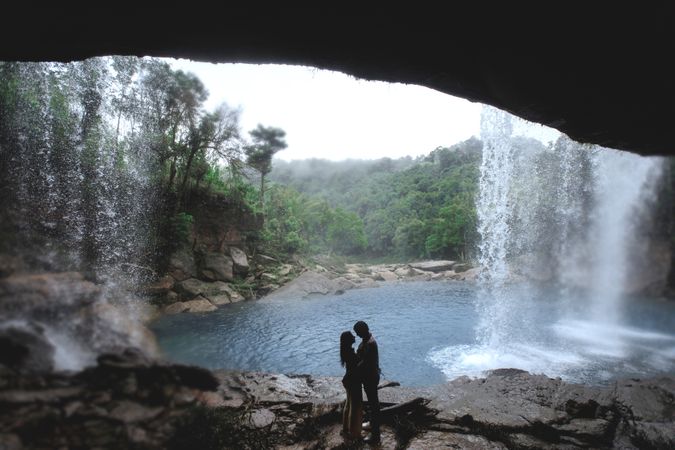 Couple Giving Romantic Pose Under Waterfall Cave Photo