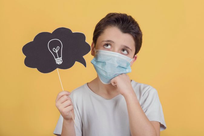 Download Premium Kid Wearing Medical Mask Think An Idea About The Covid 19 Vaccine Over Yellow Background Photo Download In Png Jpg Format PSD Mockup Templates