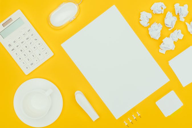 Top View Of Blank Sheet Of Paper, Crumpled Papers, Notes, Calculator And Computer Mouse Isolated On Yellow Photo