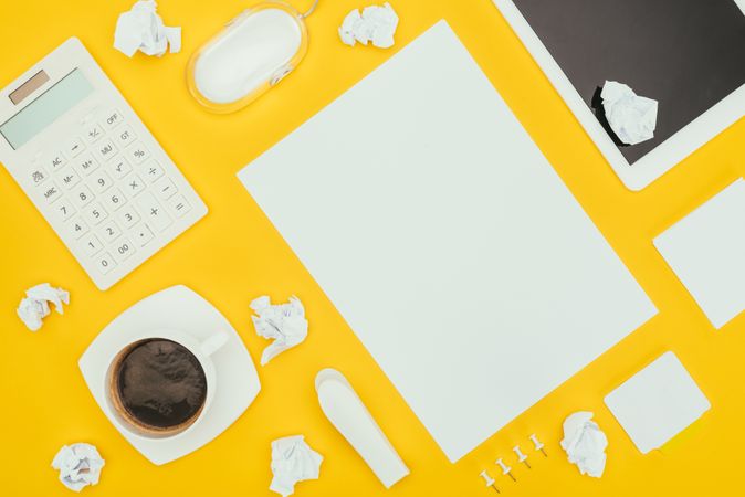 Top View Of Blank Sheet Of Paper, Crumpled Papers, Notes, Calculator And Digital Tablet Isolated On Yellow Photo