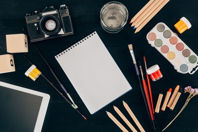 Top View Of Composition Of Colorful School Supplies With Blank Notebook Isolated On Dark Board Background Photo