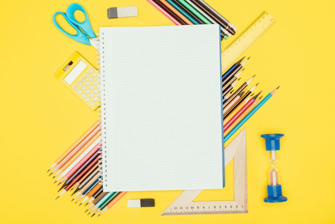 Top View Of Composition Of Colorful School Supplies With Blank Notebook Isolated On Yellow Background Photo