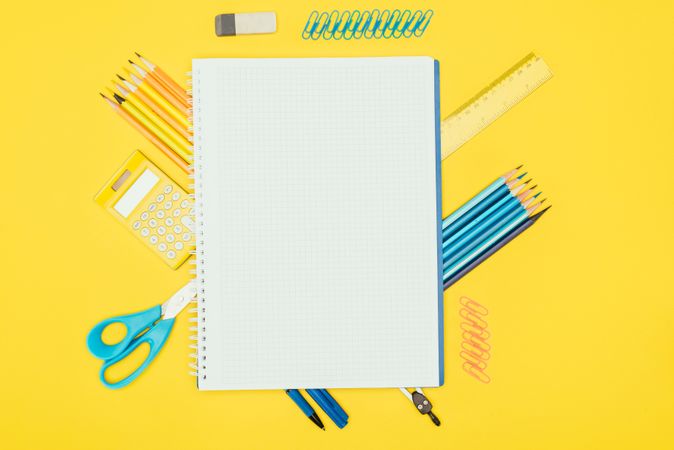 Top View Of Composition Of Colorful School Supplies With Blank Notebook Isolated On Yellow Background Photo